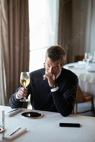 Handsome businessman drinking wine. Businessman enjoying in the restaurant