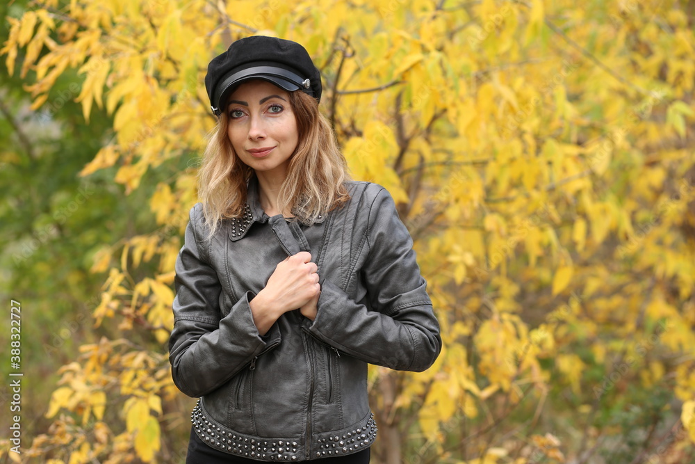 Beautiful woman and yellow leaves in the park in autumn