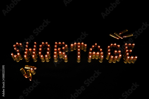 Ammo shortage spelled out with 9mm cartridges on dark background.