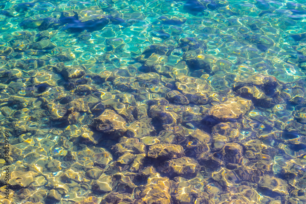rocks and reflections in the blue sea