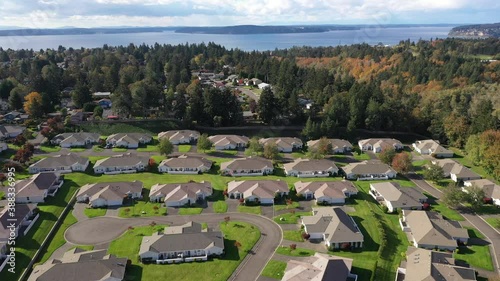 Drone / aerial footage of cookie-cutter, trackt housing and its surrounding residential area, park and scenic landscape in Lakewood, Tacoma, Pierce County Washington photo