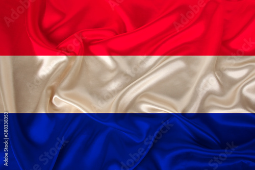 national flag of the country Holland on gentle silk with wind folds, travel concept, immigration, politics, copy space, close-up