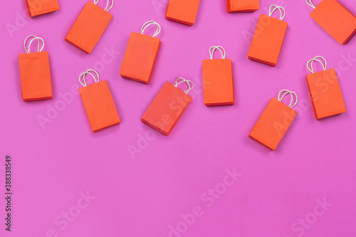 online shopping concept. many red shopping bags on pink background.  concept of shopping . copy space.