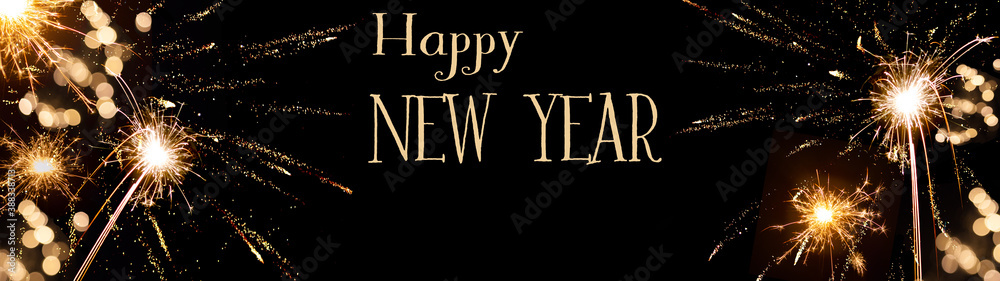 Obraz premium Happy New Year background banner panorama - sparklers firework and bokeh lights on black night texture, with space for text