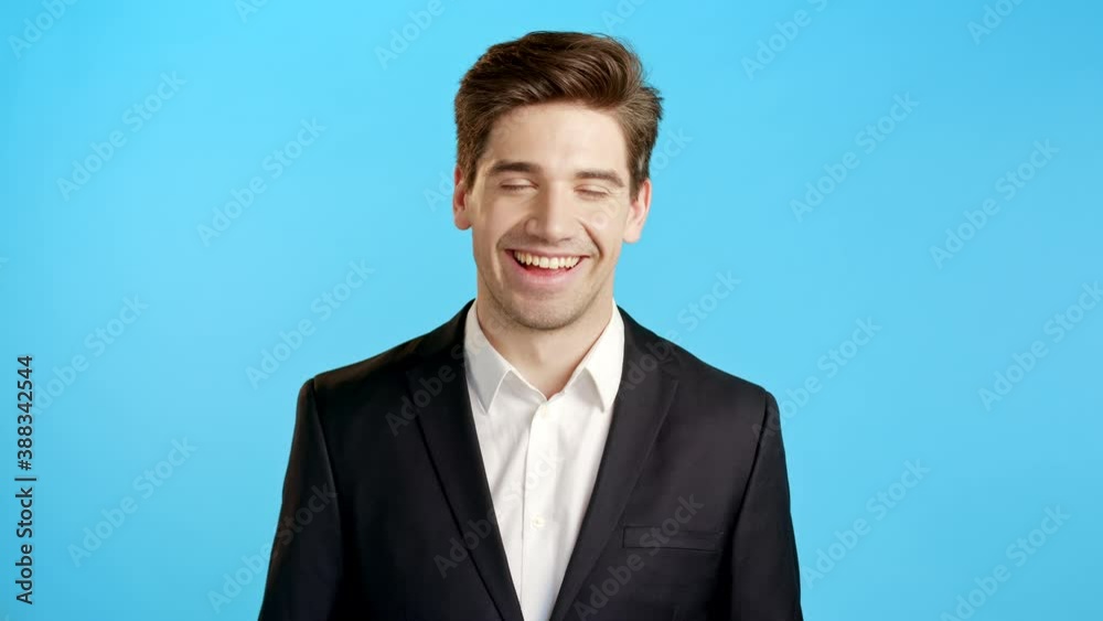 Portrait of glad happy businessman smiling isolated on blue studio background. Man in business suit looking to camera. Portraiture of handsome guy show surprise. Portrait of glad happy businessman smiling isolated on blue studio background. Man in business suit looking to camera. Portraiture of handsome guy show surprise.