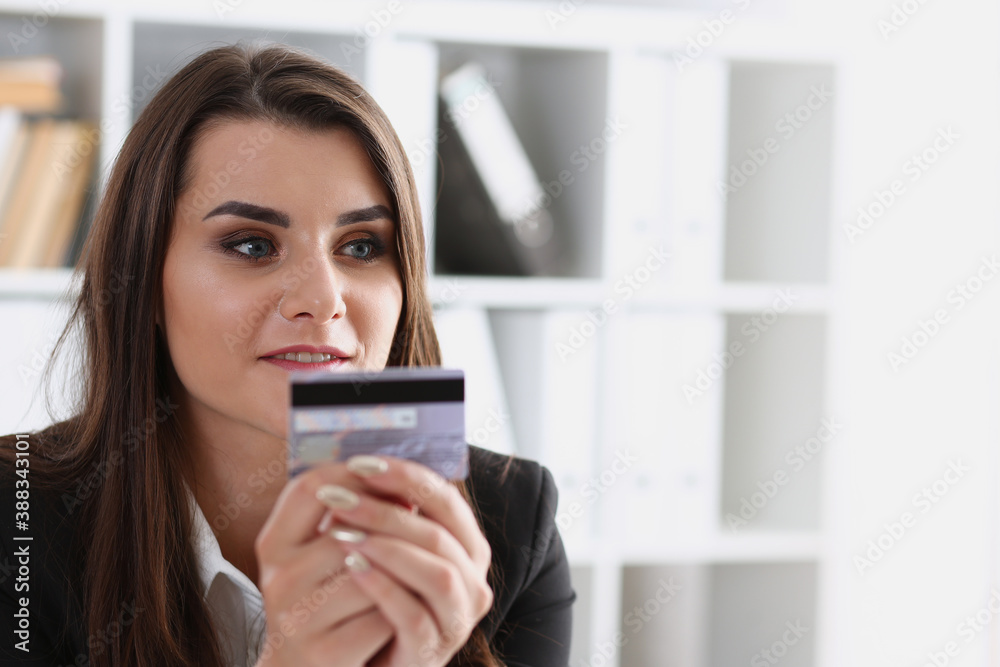 Business woman in the office holds a plastic credit debit card in her hand makes online purchases content commerce on the Internet shop ecommerce Business woman in the office holds a plastic credit debit card in her hand makes online purchases content commerce on the Internet shop ecommerce