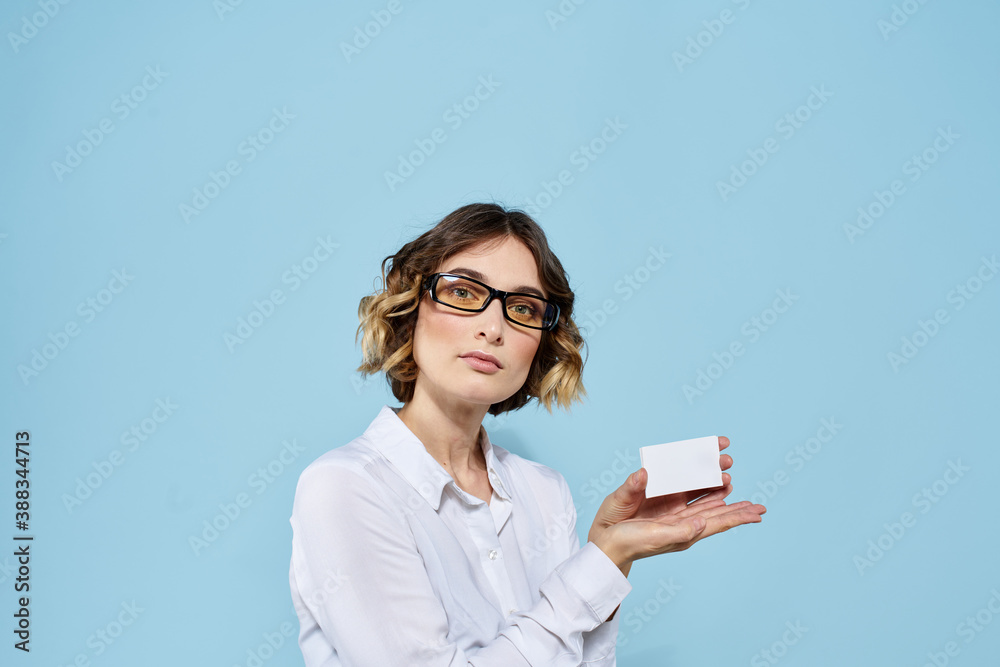Woman wearing business card glasses in hands on blue background Copy Space cropped view