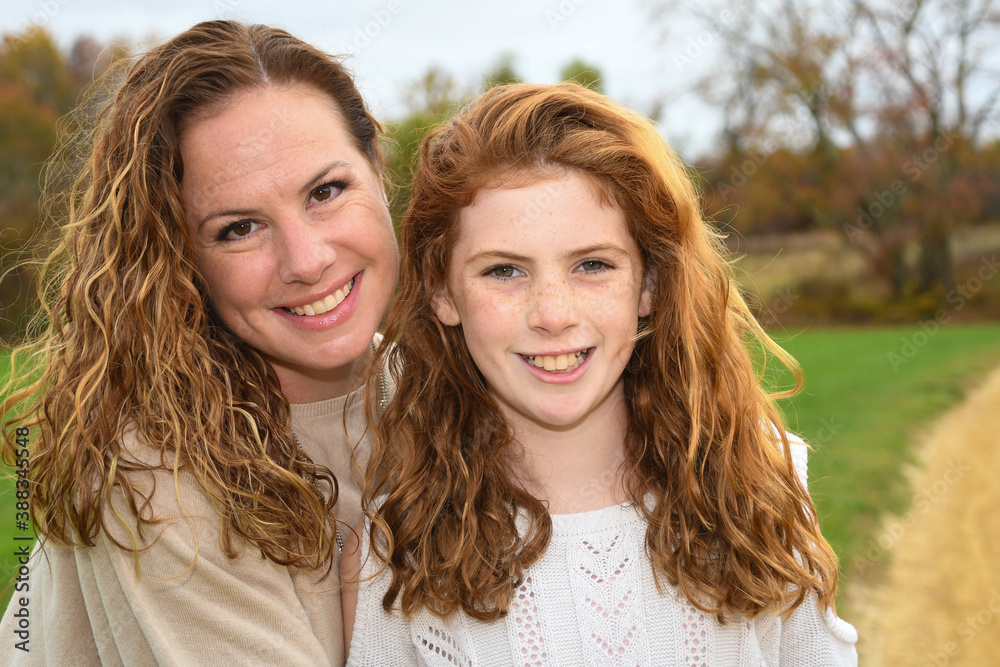 Mother and daughter pose for autumn portrait. Mother and daughter pose for autumn portrait.
