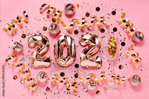 Festive New Year Flatlay background pink gold foil balloons and chrtistmas decorations. Top horizontal view copyspace. photo