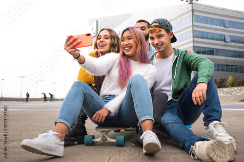 Happy group of friends takes a selfie outdoor. photo