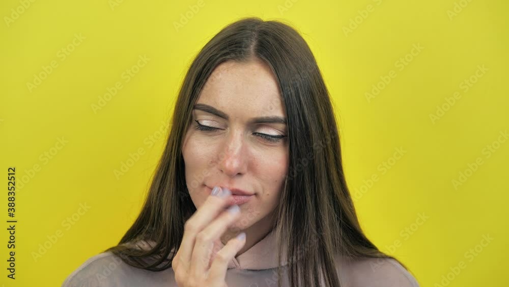 Portrait of young woman isolated on yellow studio background shouting for joy and raising finger with great idea gesture, girl amazed surprised by suddenly found answer, genius plan Portrait of young woman isolated on yellow studio background shouting for joy and raising finger with great idea gesture, girl amazed surprised by suddenly found answer, genius plan