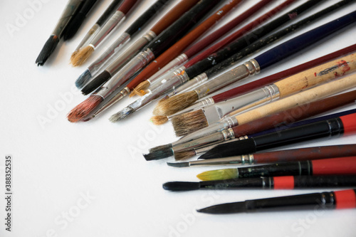 group of different sizes paint brushes on white background. Equipment for painting. Craft material proffesional brush for art 