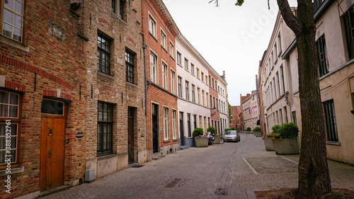 Fototapeta Naklejka Na Ścianę i Meble -  Bruges, Belgium - May 12, 2018:  Roofs And Windows Of Old Authentic Brick Houses On Street Ontvangers-straat