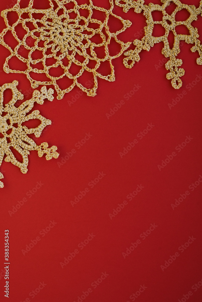 Gold crocheted snowflakes on a red background Gold crocheted snowflakes on a red background