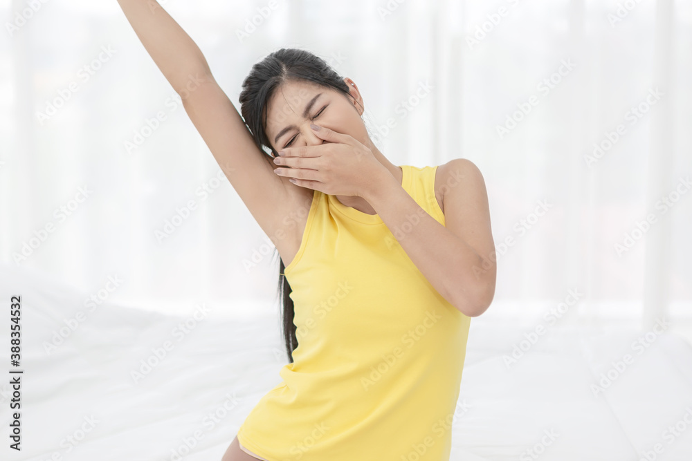 Young woman wake up in the morning and stretching on her bed Young woman wake up in the morning and stretching on her bed
