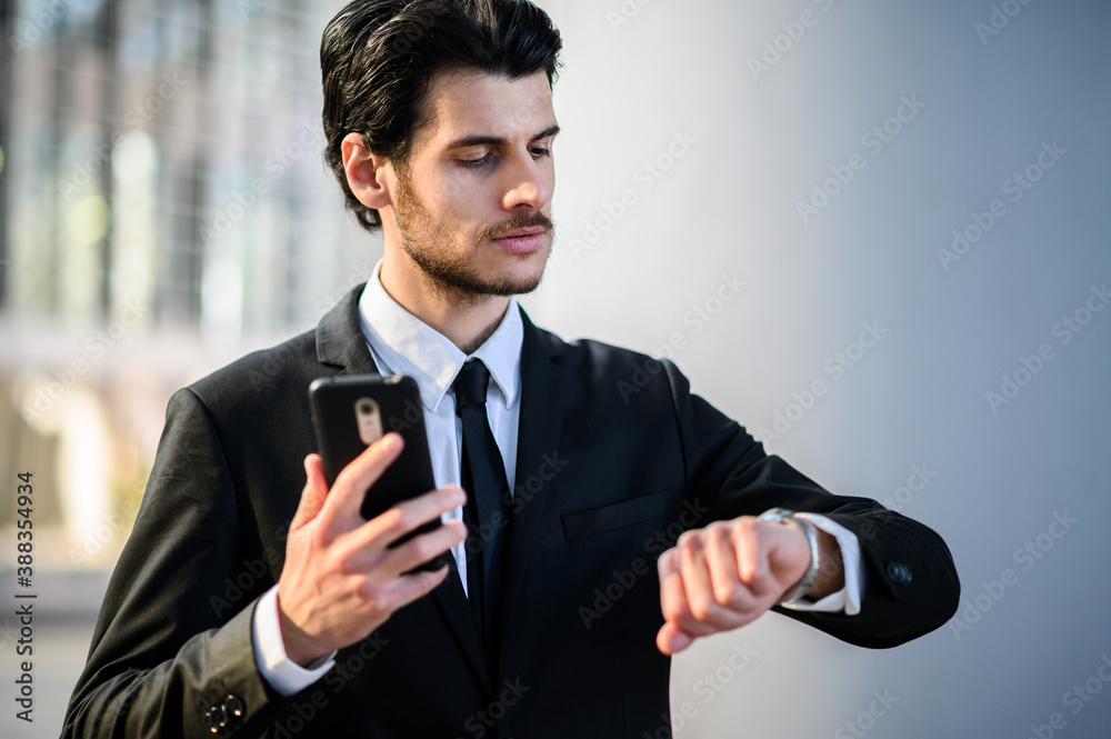 Businessman watching the time in a modern city Businessman watching the time in a modern city