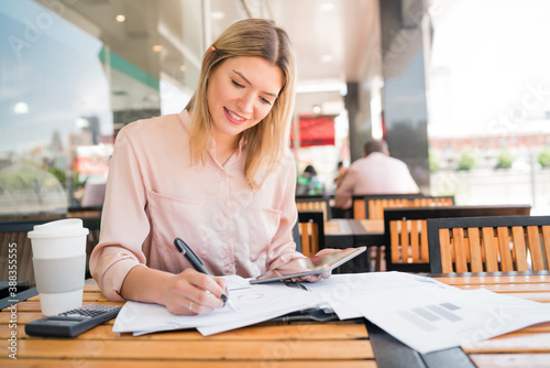 Young businesswoman working with a digital tablet.