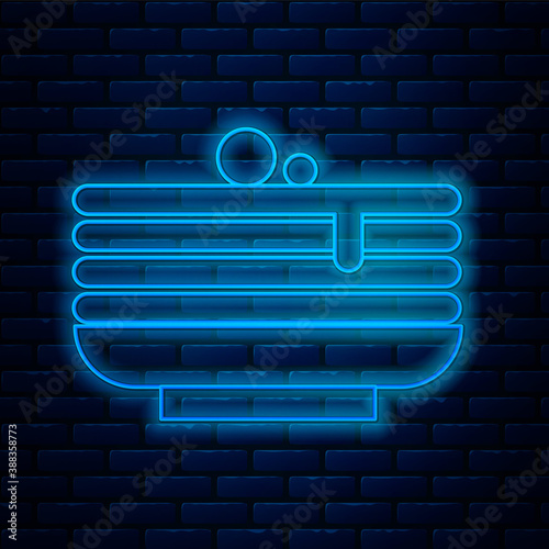 Glowing neon line Stack of pancakes icon isolated on brick wall background. Baking with syrup and cherry. Breakfast concept. Vector.