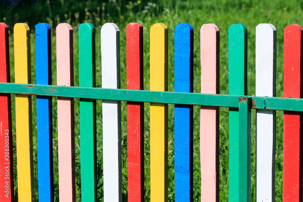 Close-up of the multicolored painted wooden fence Close-up of the multicolored painted wooden fence