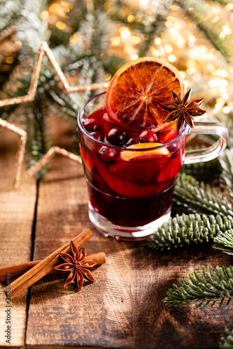Fototapeta Naklejka Na Ścianę i Meble -  Christmas mulled wine with spices on a wooden rustic table.