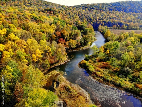 The aerial view of the striking colors of fall foliage by the river near Tunkhannock, Pennsylvania, U.S.A