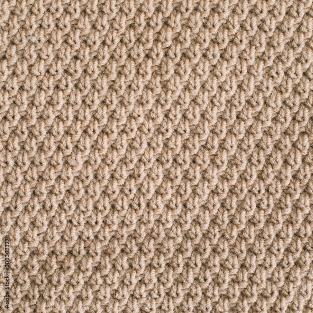Knitted texture background. Knitting pattern of wool. Knitting. Texture of woolen fabric for wallpaper and abstract background.