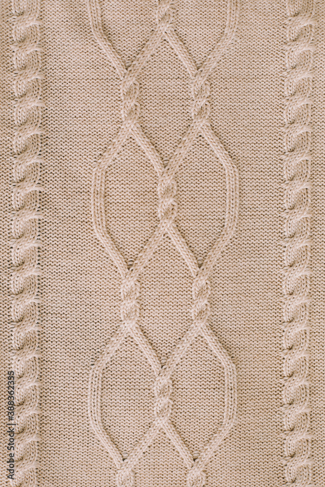Knitted texture background. Knitting pattern of wool. Knitting. Texture of woolen fabric for wallpaper and abstract background. Knitted texture background. Knitting pattern of wool. Knitting. Texture of woolen fabric for wallpaper and abstract background.