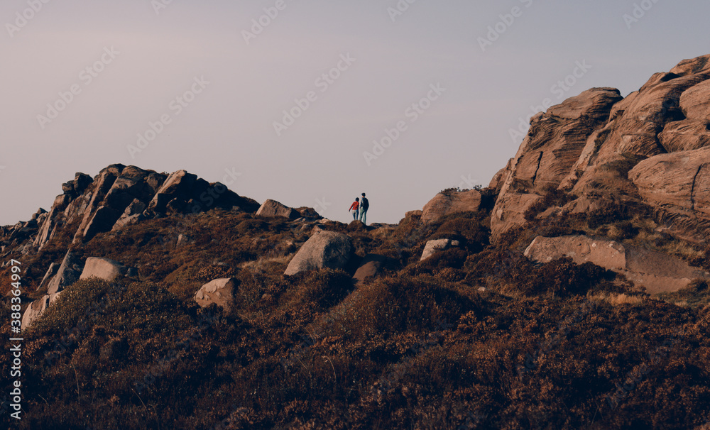 Couple hiking. The Roaches. Peak District of England. Landscape. Mountain. Rocks. Couple hiking. The Roaches. Peak District of England. Landscape. Mountain. Rocks.