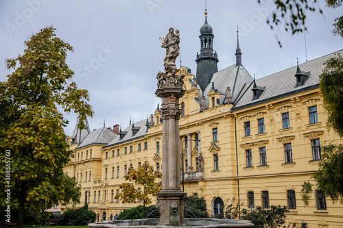 Fountain with a statue of St. Josefa at Charles Square near the renaissance building of Municipal Court and New Town Hall in the center of Prague, Czech Republic photo