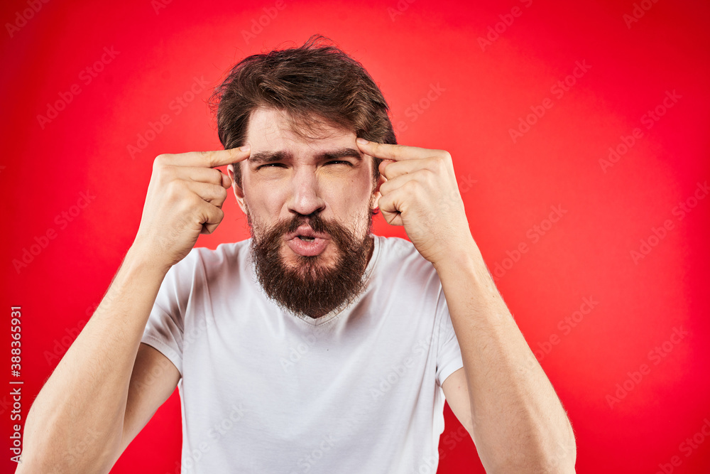 Fototapeta premium bearded man gesturing with hands white t-shirt emotions facial expression aggression red isolated background