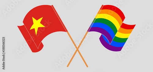 Crossed and waving flags of Vietnam and LGBTQ.