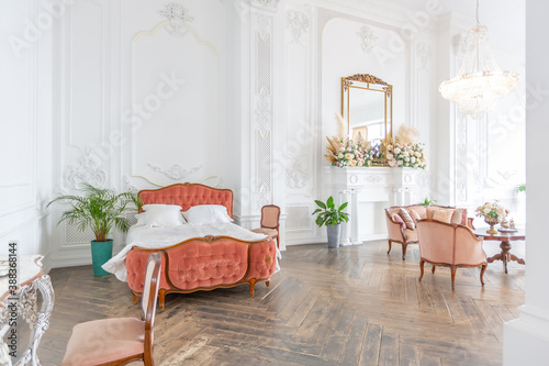 royal baroque style luxury posh interior of large room. extra white, full of day light. high ceiling and walls decorated by stucco