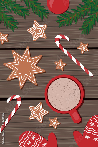 red cup with cappuccino, Christmas gingerbread stars, cane lollipops, red mittens and sprigs of spruce on a wooden background. view from above. flat style, christmas background