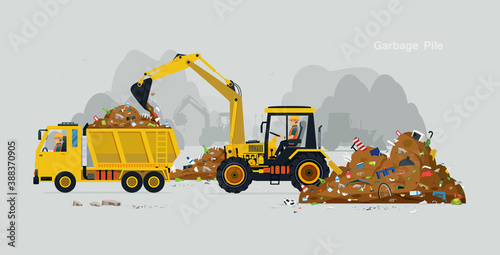 The workers drive the excavator to collect the garbage into the truck.
