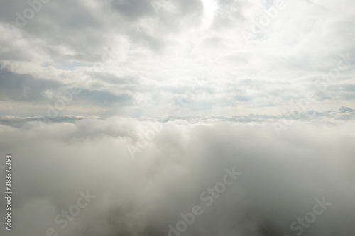 Panoramic view of beautiful blue sky with clouds and sun lights. View above clouds.