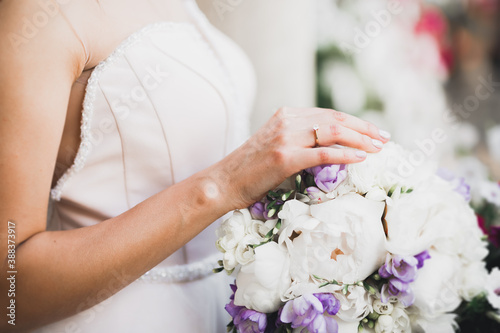 Bride holding big and beautiful wedding bouquet with flowers