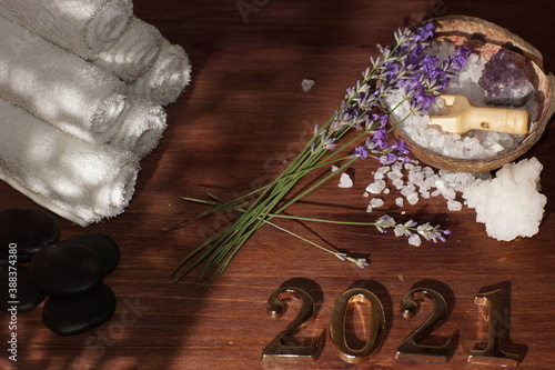 Spa set and golden numbers 2021, purple fresh lavender flowers lie nearby