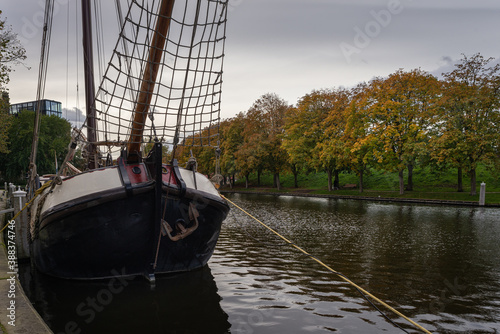 Traditional Dutch boat in the canal near the City Gate Zijlpoort photo