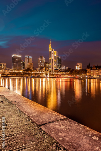 downtown city at night, skyline reflection in main river 