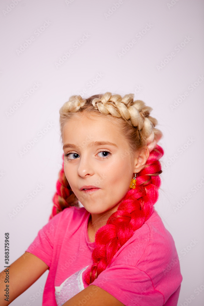 cute girl in bright colorful clothes and with colored braids