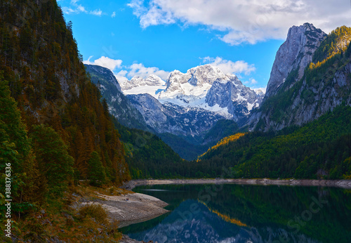 Fototapeta Naklejka Na Ścianę i Meble -  Beautiful Gosausee lake landscape with Dachstein mountains, forest, clouds and reflections in the water in Austrian Alps