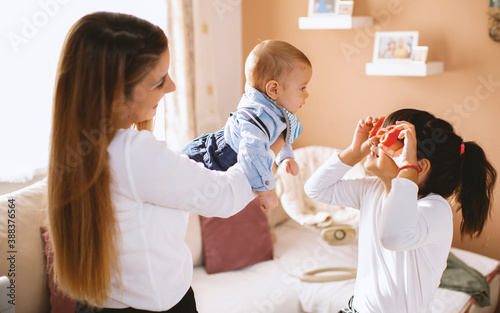 Young mother and children preparing meal with healthy food