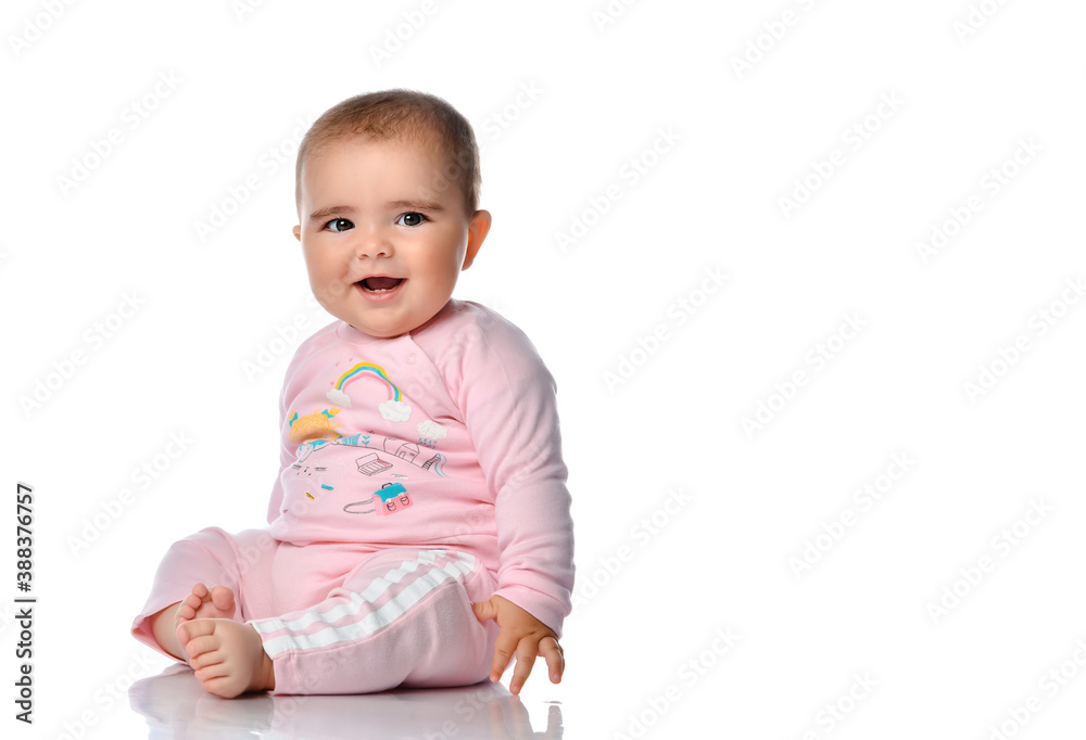 Cute little girl laughs looking at the camera on a white background. Cute little girl laughs looking at the camera on a white background.