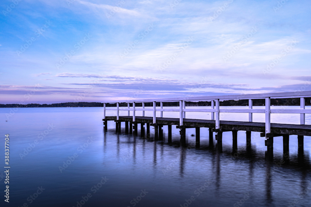 footbridge in the lake, sunset reflection footbridge in the lake, sunset reflection