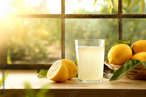 Homemade lemonade on kitchen with window and orchard outside Fototapet