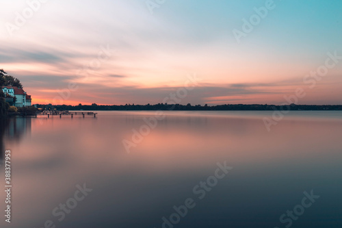 sunset reflection over the lake, footbridge and house on the water, Bad Zwischenahn