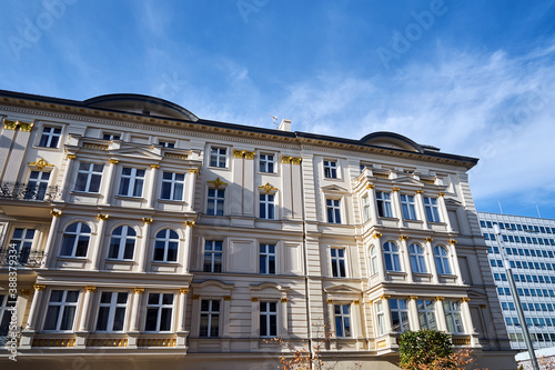 Fototapeta Naklejka Na Ścianę i Meble -  the facade of a historic tenement house and a modern office building