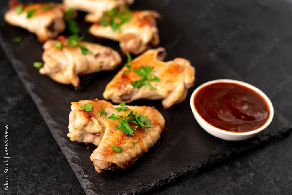 grilled chicken wings with sauce on stone background. selective focus grilled chicken wings with sauce on stone background. selective focus