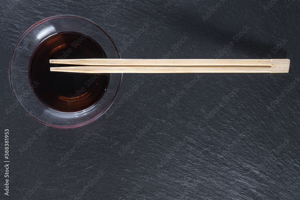 Sushi sticks and soy sauce in a Cup. Flat layout. Space for text Sushi sticks and soy sauce in a Cup. Flat layout. Space for text