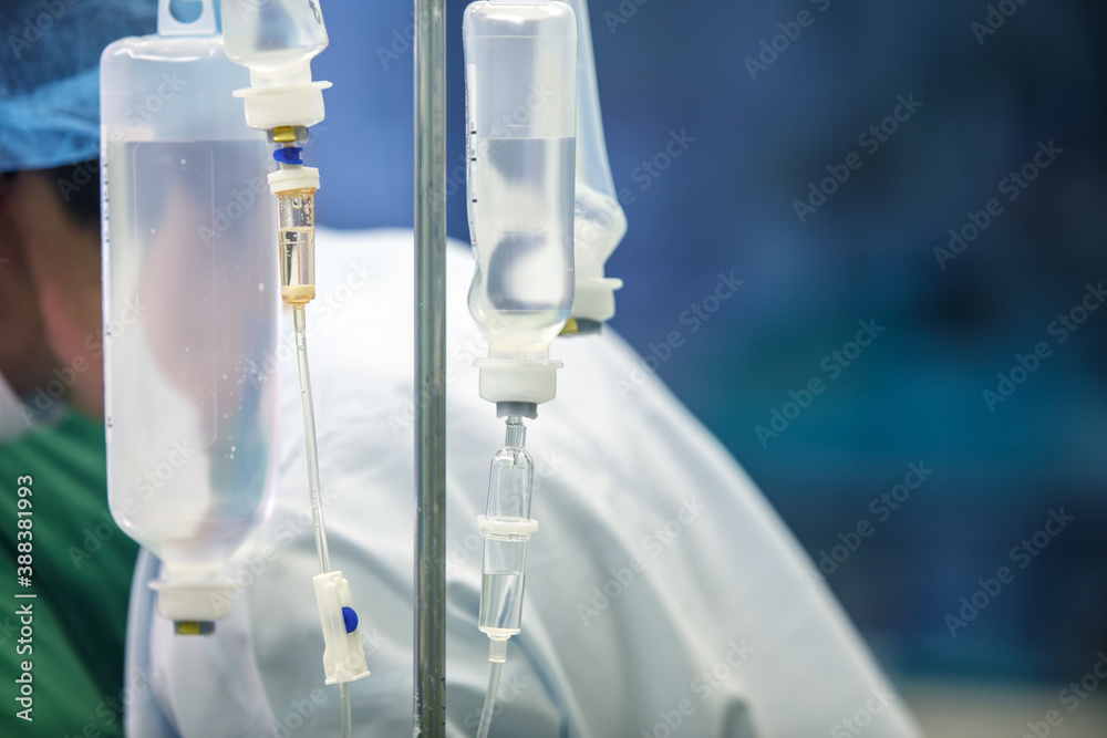 Dropper with medicine on the background of medical workers. Selective focus. Copy space Dropper with medicine on the background of medical workers. Selective focus. Copy space
